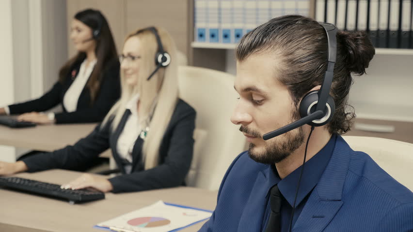 Sales marketing people in the office talking on the headphone set. Marketing and sales Royalty-Free Stock Footage #34233124