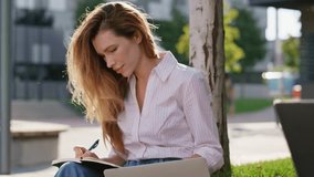 Attractive woman study outdoors talking friend closeup. Smiling freelance partners work remotely browsing laptop in urban park. Friendly businesswoman making notes. Busy couple chatting on street. - Powered by Shutterstock - Get 15% off with code: PIKWIZARD15