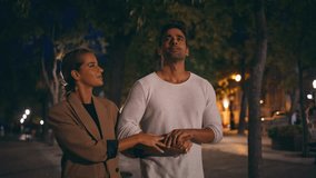 Romantic pair going evening street together. Affectionate cute people kissing walking park at night. Happy carefree lovers enjoying date hugging outside. Cheerful loving spouses having conversation - Powered by Shutterstock - Get 15% off with code: PIKWIZARD15