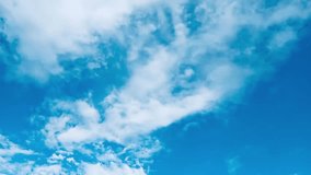Time lapse clouds and bright blue sky, circle of white clouds over blue sky with sunlight, time lapse video of clouds in motion, blue sky nature bright white weather.