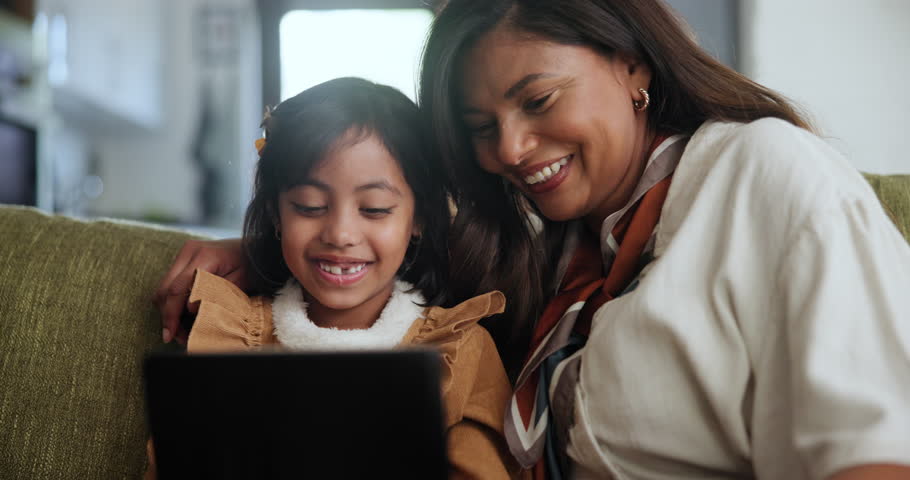 Tablet, search and mother and daughter on a sofa with cartoon, streaming or gaming in their home together. Digital, love and mom with girl child in a living room with app for playing, video or ebook