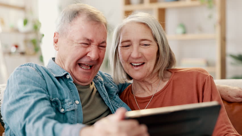 Senior couple, tablet and selfie for social media, app and laughing for joke at home. Happy elderly people, technology and camera application for photography, bonding and love or funny face for humor Royalty-Free Stock Footage #3423447231