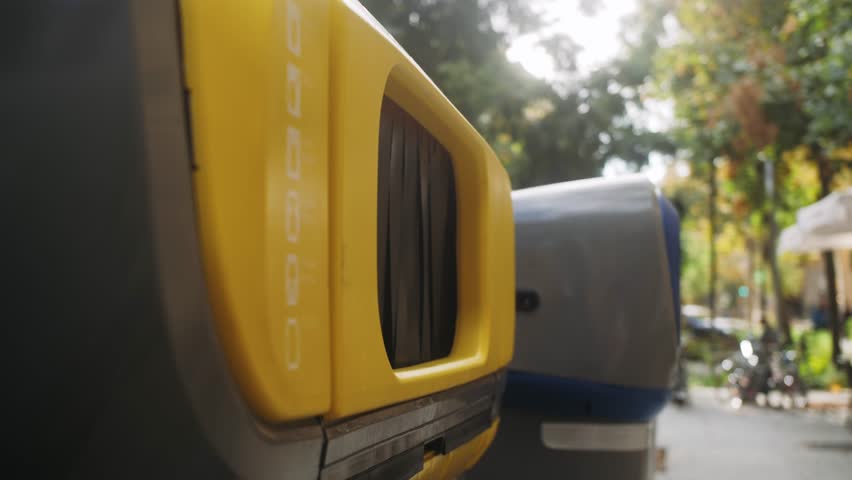 Close-up of hand throwing empty plastic bottle in recycling bin.