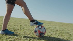 Young athletic woman in sports uniform juggling a soccer ball with legs while training on field on sunny summer day - Powered by Shutterstock - Get 15% off with code: PIKWIZARD15