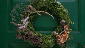 Beautiful entrance to scandinavian style house with wooden door and christmas wreath. Homemade diy xmas decoration. Winter city doors and landscape. Inspiring winter ornaments and nordic lifestyle - Powered by Shutterstock - Get 15% off with code: PIKWIZARD15