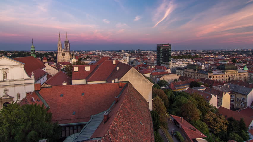 Kaptol and catholic cathedral day to night transition timelapse in the center of Zagreb, Croatia, panoramic top view of downtown from Kula Lotrscak tower after sunset