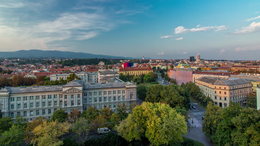 Panorama of the city center day to night transition timelapse shoot from top of the skyscraper with aerial view to intersection in front of national theater and museum in Zagreb, Croatia after sunset