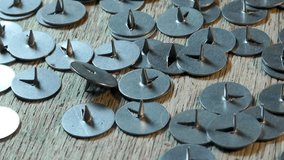 Many metal buttons scattered on the surface close-up