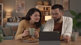 Couple caucasian man and woman husband and wife or boyfriend and girlfriend use laptop computer and credit card shopping online buy stuff or pay make payment booking e-commerce from home real people - Powered by Shutterstock - Get 15% off with code: PIKWIZARD15