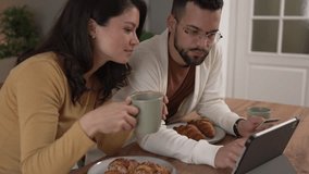 Couple caucasian man and woman husband and wife or boyfriend and girlfriend use laptop computer and credit card shopping online buy stuff or pay make payment booking e-commerce from home real people - Powered by Shutterstock - Get 15% off with code: PIKWIZARD15