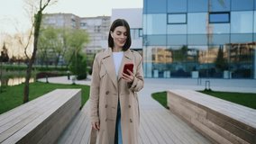 Businesswoman Going Live on Social Media App while Walking near Local Lake. Happy Lady Using Gadget for Voice Commands Outside. People and Technology Concept