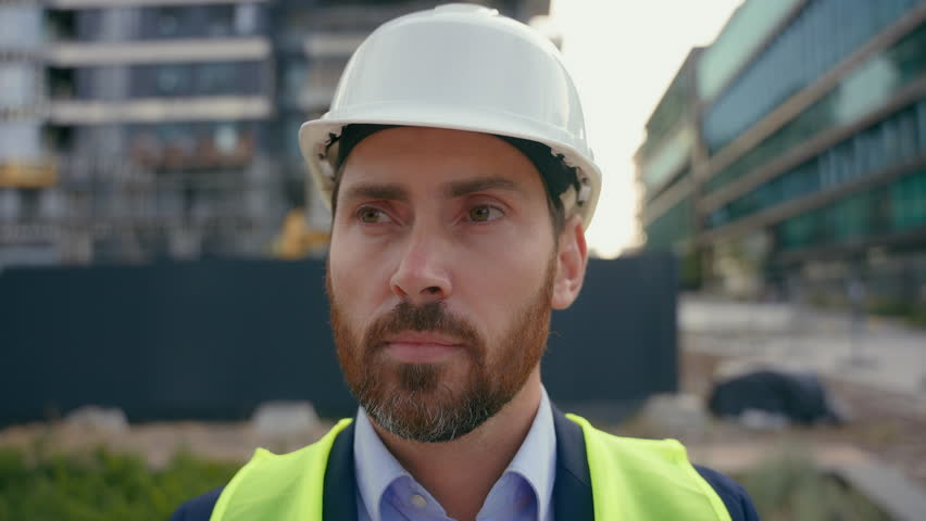 Portrait close up man worker repairman in safety helmet looking around smile male contractor wearing hardhat architect smiling city urban building architecture builder construction engineer specialist Royalty-Free Stock Footage #3423880163