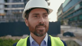 Portrait close up man worker repairman in safety helmet looking around smile male contractor wearing hardhat architect smiling city urban building architecture builder construction engineer specialist - Powered by Shutterstock - Get 15% off with code: PIKWIZARD15