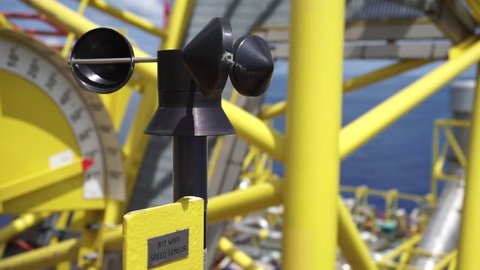 An industrial wind speed sensor attached to pedestal crane at oil and gas platform.
