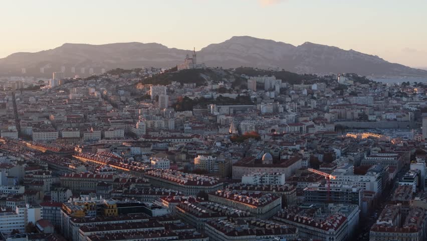 Marseille - France - 12 20 2023 - Aerial view of the Vieux Port and the Panier with the basilica Notre Dame de la Garde in the background