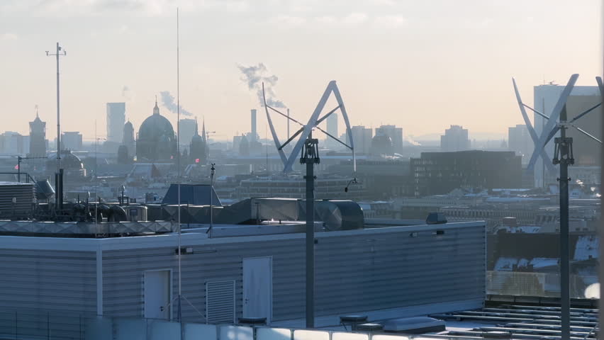 Vertical-axis wind turbine generating renewable energy on a rooftop 