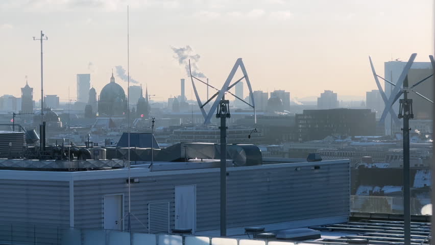 Vertical-axis wind turbine generating renewable energy on a rooftop  Royalty-Free Stock Footage #3423954239
