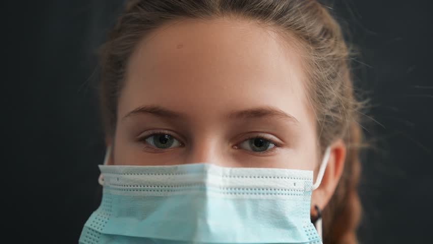 Happy family concept.close up of girls face in medical mask.woman looks at camera.face mask protects against virus.girl at home wearing medical mask.protection of respiratory tract from infection Royalty-Free Stock Footage #3423987417