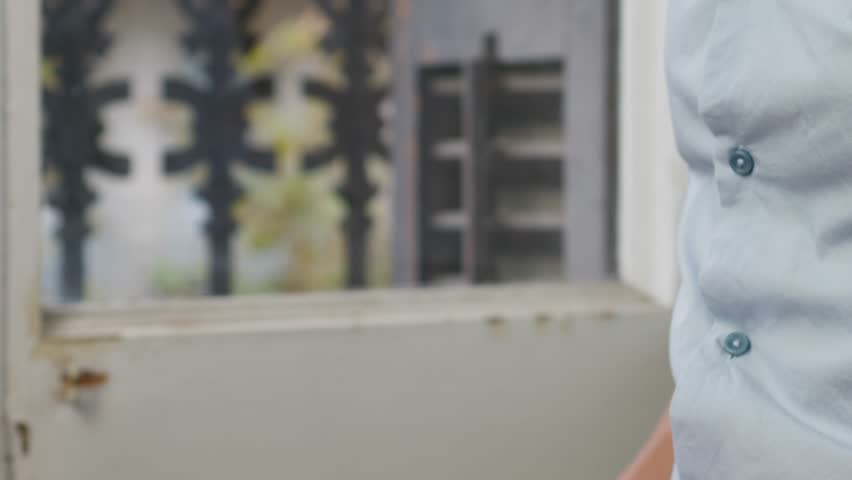 Young man squeezing a white moisturizer from a tube on his hand close-up. Morning routine. Beauty and care concept.