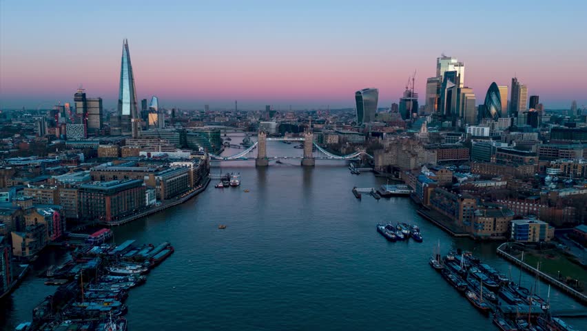 Aerial dawn to sunrise hyperlapse view of the Tower Bridge and skyline of London, England