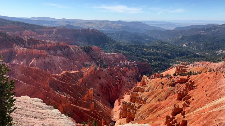 A wide, static view of beautiful canyons and river valleys from a top of a mountain in Zion National Park in Utah