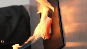 The flames of fire burn the sushi. Cooking sushi. Close-up. - Powered by Shutterstock - Get 15% off with code: PIKWIZARD15