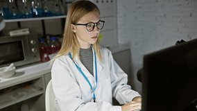 Blonde woman scientist analyzing data on computer in laboratory - Powered by Shutterstock - Get 15% off with code: PIKWIZARD15