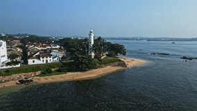 Drone footage of Galle Fort Sri Lanka showcases coastal defenses, historical architecture, lighthouse, tropical palms, Indian Ocean. Perfect for travel, history, culture, tourism, aerial landscape.