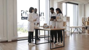 Human skeleton model on the table in classroom. Group of international medical students with male senior teacher standing near table and having anatomy lesson. - Powered by Shutterstock - Get 15% off with code: PIKWIZARD15