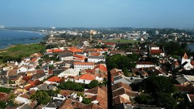 Drone view of Galle Fort, ancient architecture, coastal landmarks, Sri Lanka heritage site. Historic buildings, lighthouse, ramparts from above. Tourist destination, aerial cityscape.