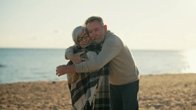 Happy laughing senior man hugging woman on sea beach at sunset in evening. Elderly couple family on important date cuddling embracing talking. Lifelong relationships and happy marriage concept. - Powered by Shutterstock - Get 15% off with code: PIKWIZARD15