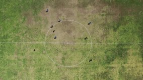 Exciting aerial 4K drone view of internationally athletic soccer players competing on grass field. Perfect clip for sports, recreation, exercise, health, physical activities, motivational advertising 