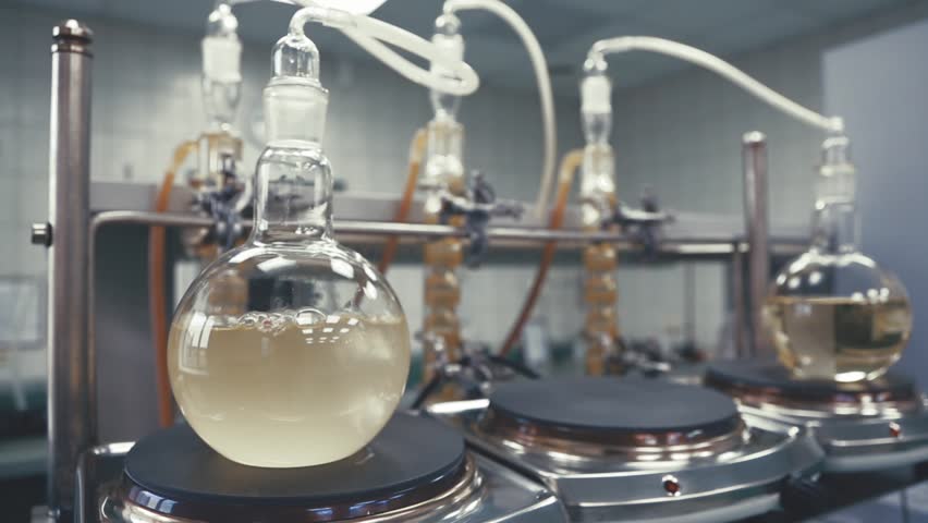 Light liquid is bubbling in a flask under laboratory conditions. Quality control in the laboratory at factory of sparkling wines. Flask is heated with large temperature on the stove in laboratory. Royalty-Free Stock Footage #34243693