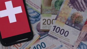 Different Swiss Francs And The National Flag On The Mobile Screen - Powered by Shutterstock - Get 15% off with code: PIKWIZARD15