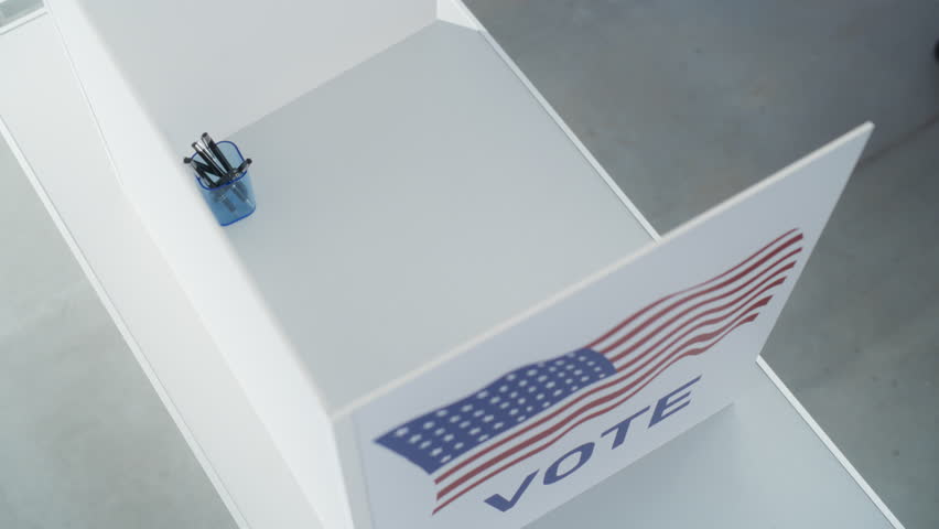 Top Down View on an Anonymous Female Filling Out a Ballot in a Voting Booth on the Day of National Elections in the United States of America. Woman Choosing to Vote for Republican Party Royalty-Free Stock Footage #3424553037