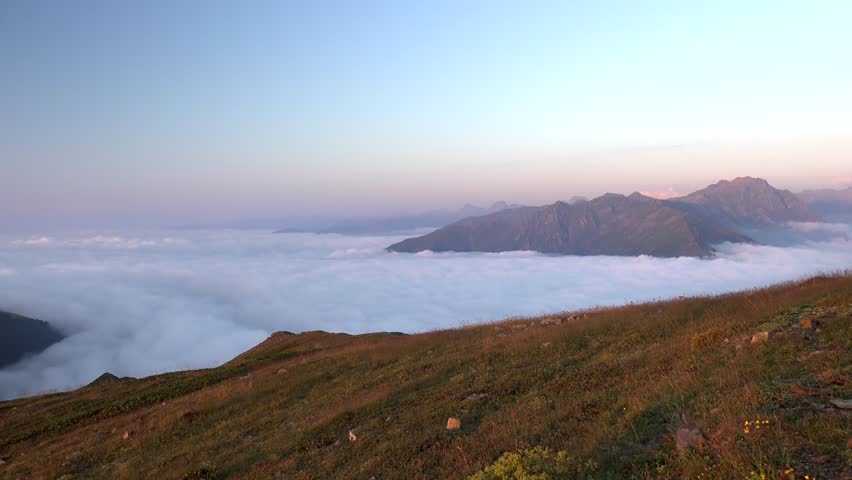 Panoramic view of slanting sun rays above the clouds from the slopes of the Andes Andean Mountain Range.