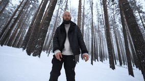 Man dancing in winter forest. Media. Stylish man filming video clip in winter forest. Shooting stylish man in winter forest