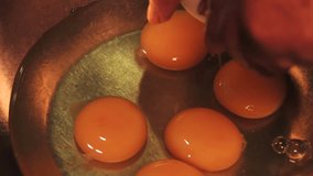 4k video breaking eggs and placing them in a bowl. Food preparation concept.