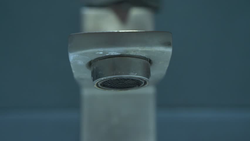 Close-up shot front view video of clean water pouring steadily from a stylish faucet, emphasizing the purity and flow of water in a modern setting. Royalty-Free Stock Footage #3424730991