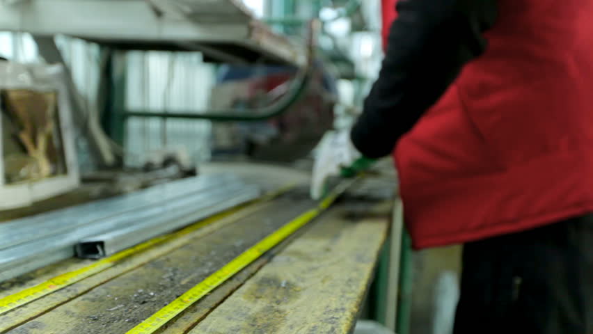 Workers in workshop. Production of plastic windows