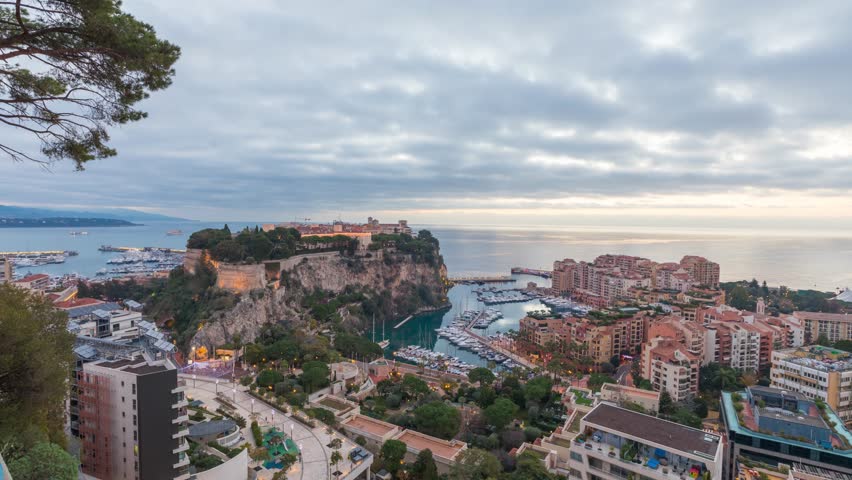 Sunrise in Monaco: zoom in view on port Fontvieille and Rock of Monaco with old town - time lapse video