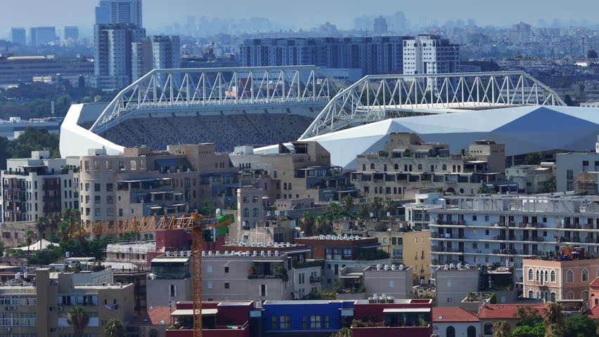 Aerial Backward Shot Of Bloomfield Football Stadium In City On Sunny Day - Tel Aviv-Yafo, Israel