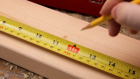 measuring a 2 x 4 with a tape measure