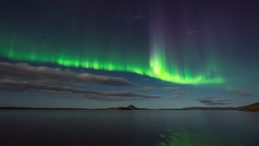 ICELAND – 2016 : Timelapse of amazing Northern Lights at Lake Myvatn at night with beautiful landscape in view