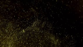 Gold ink in water shooting with high speed camera. Gold glitter background with sparkle shine light confetti. Super Slow Motion at 1000fps.  