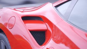 4k HDR stock footage of a bright red sports car closeup detail