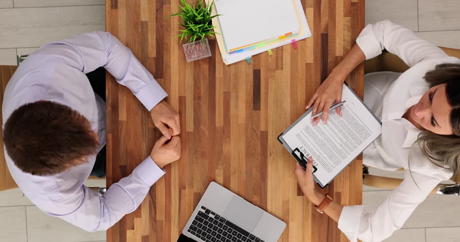 Businessman signs contract and has a successful meeting on business agreement in office. Enthusiastic client signs on official loan document