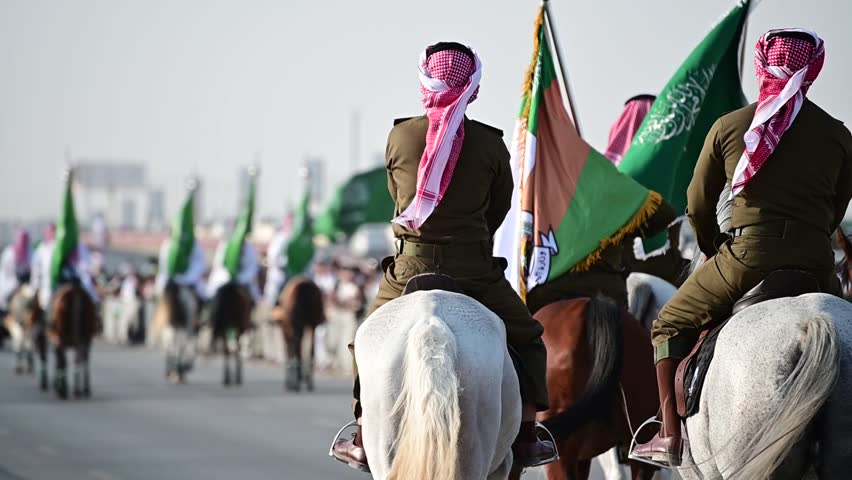 Riyadh, Saudi Arabia – September 21st 2023: Celebrating national and founding day in Riyadh the capital of Saudi Arabia. Group of knights with traditional dress holding the Saudi national green flag Royalty-Free Stock Footage #3425086241