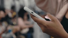 Close-up View of the Girl Hand, Standing in Subway and Using Phone, Watching Video, Scrolls Through News. Business Woman Chats Using Smartphone on Subway. Travel and Technology - Powered by Shutterstock - Get 15% off with code: PIKWIZARD15