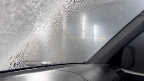 Robot car wash with foam. Automatic car wash view from the car cabin. View of an automatic car windshield wash with foam. Sliding foam from the windshield. - Powered by Shutterstock - Get 15% off with code: PIKWIZARD15